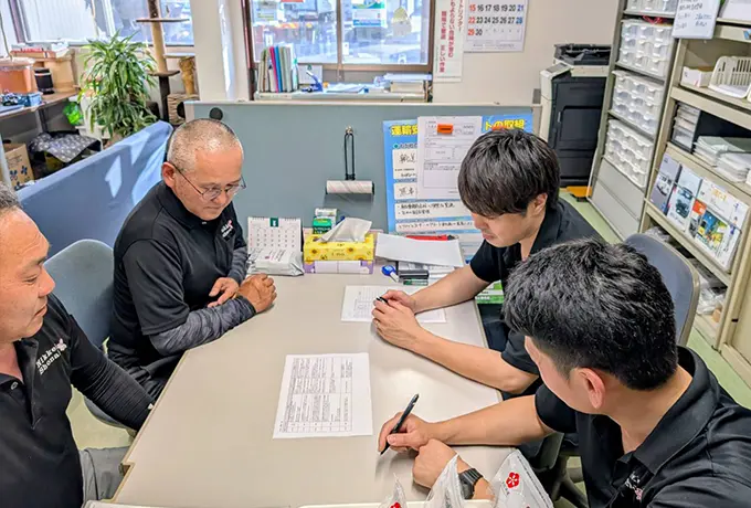 職場で打合せしている様子